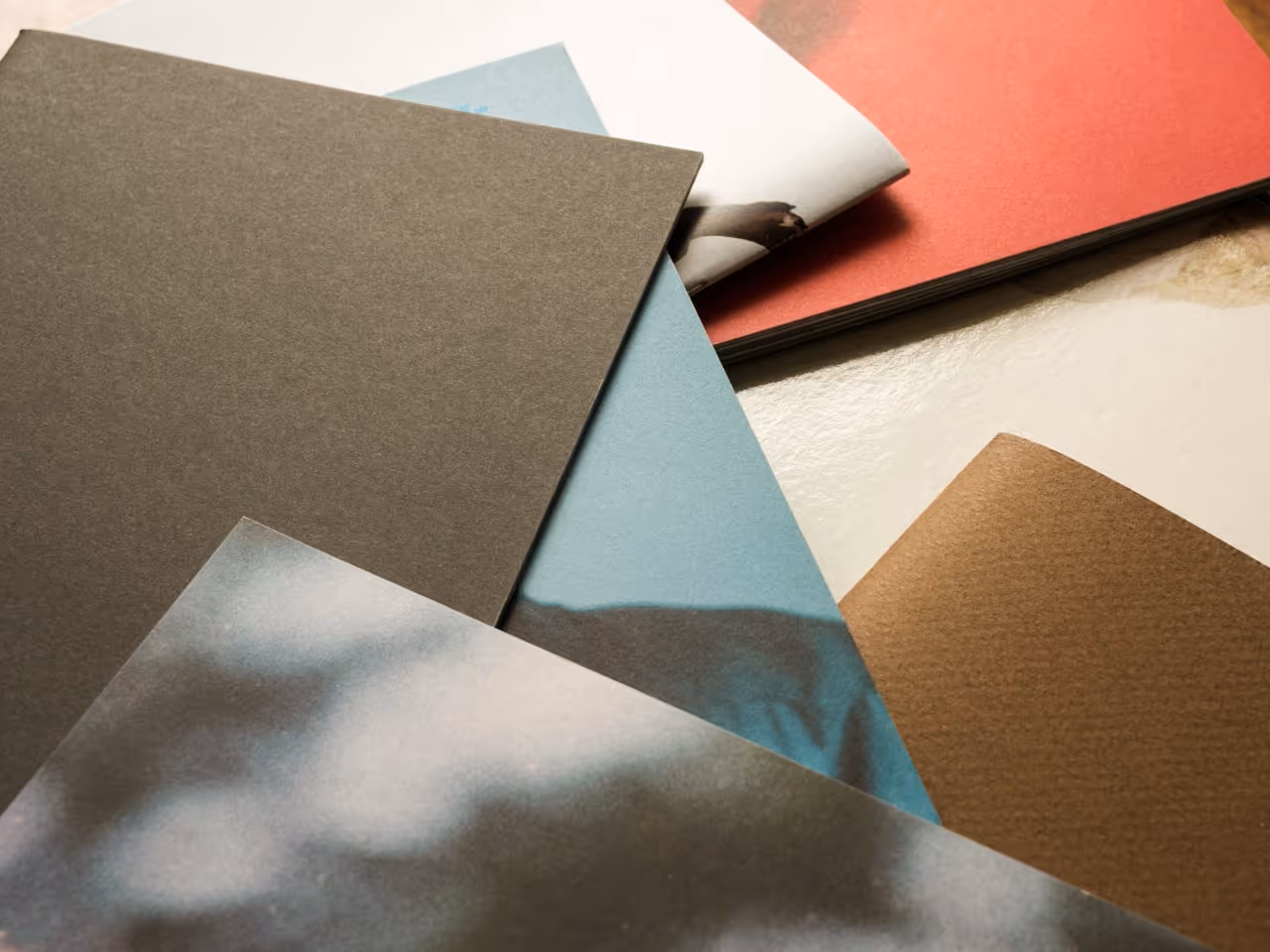 flatlay of various coloured and printed paper on a table