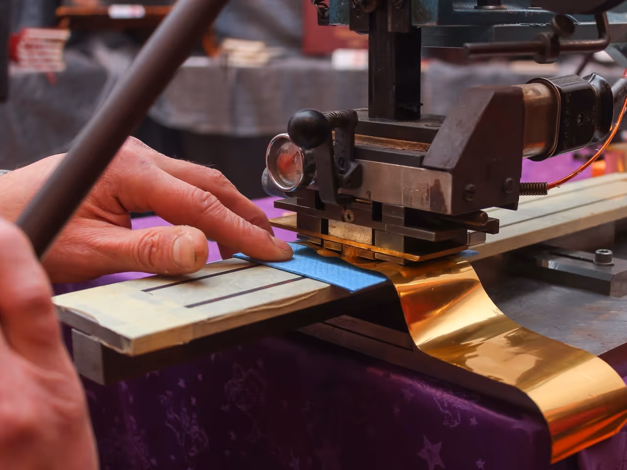 person using a gold foil stamping machine