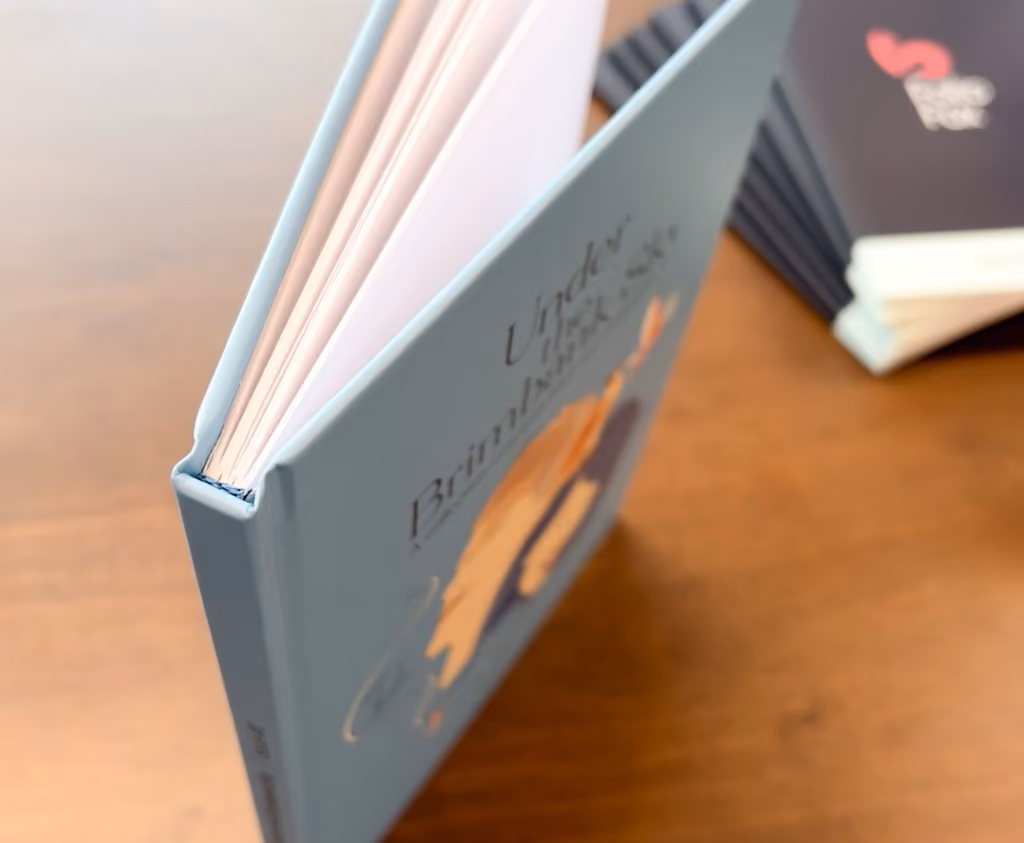 hardcover book printed by foliofox on a table, standing upright.
