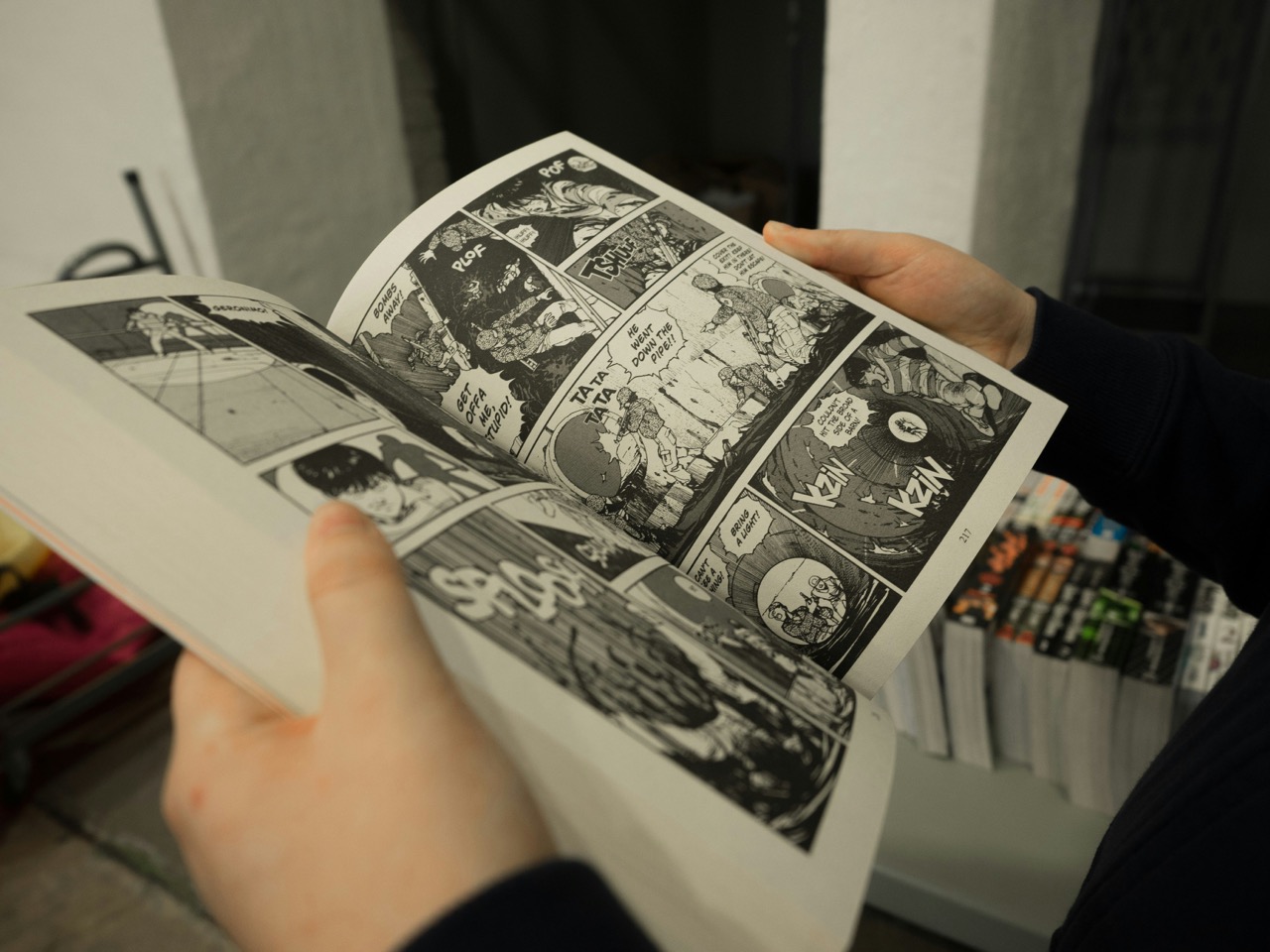 person opening graphic novel book. Image source: Miika Laaksonen on Unsplash