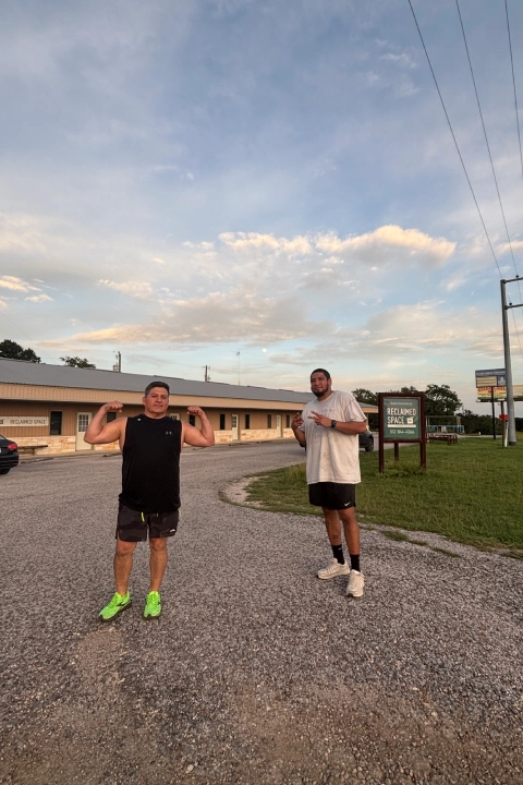 Two men standing in the middle of a road at On The Block Fitness in Lockhart, TX.