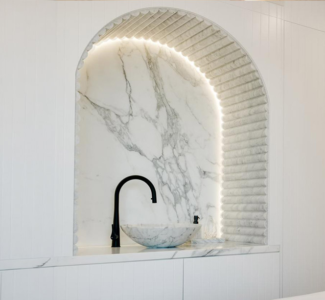 Stone-lined wall niche framing a single beautiful object in a home.