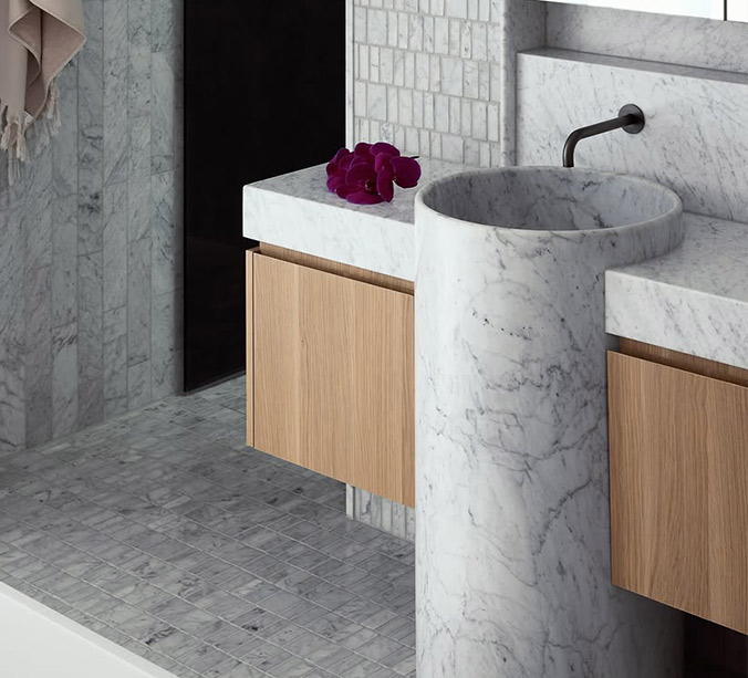 Vanity basin carved seamlessly from a single piece of natural stone.