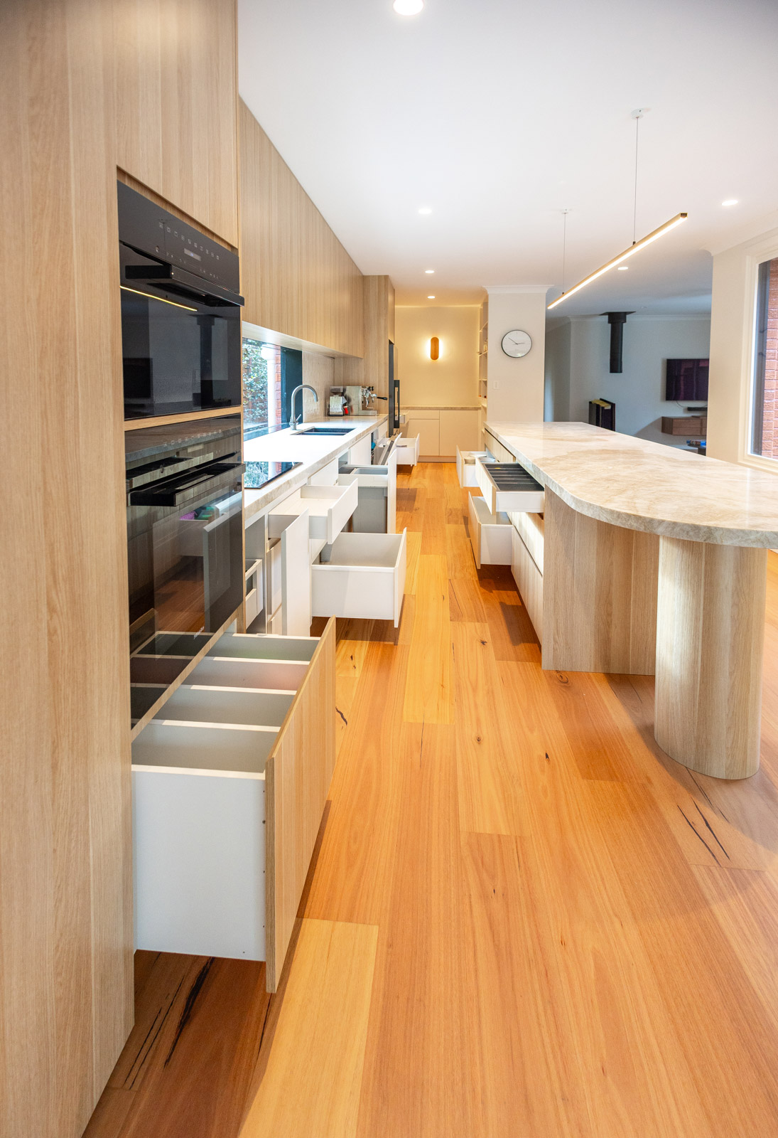 Dedicated pull-out drawers for pots, cutlery and waste in custom kitchen joinery