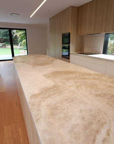 Close-up of book-matched Taj Mahal quartzite veining on kitchen island