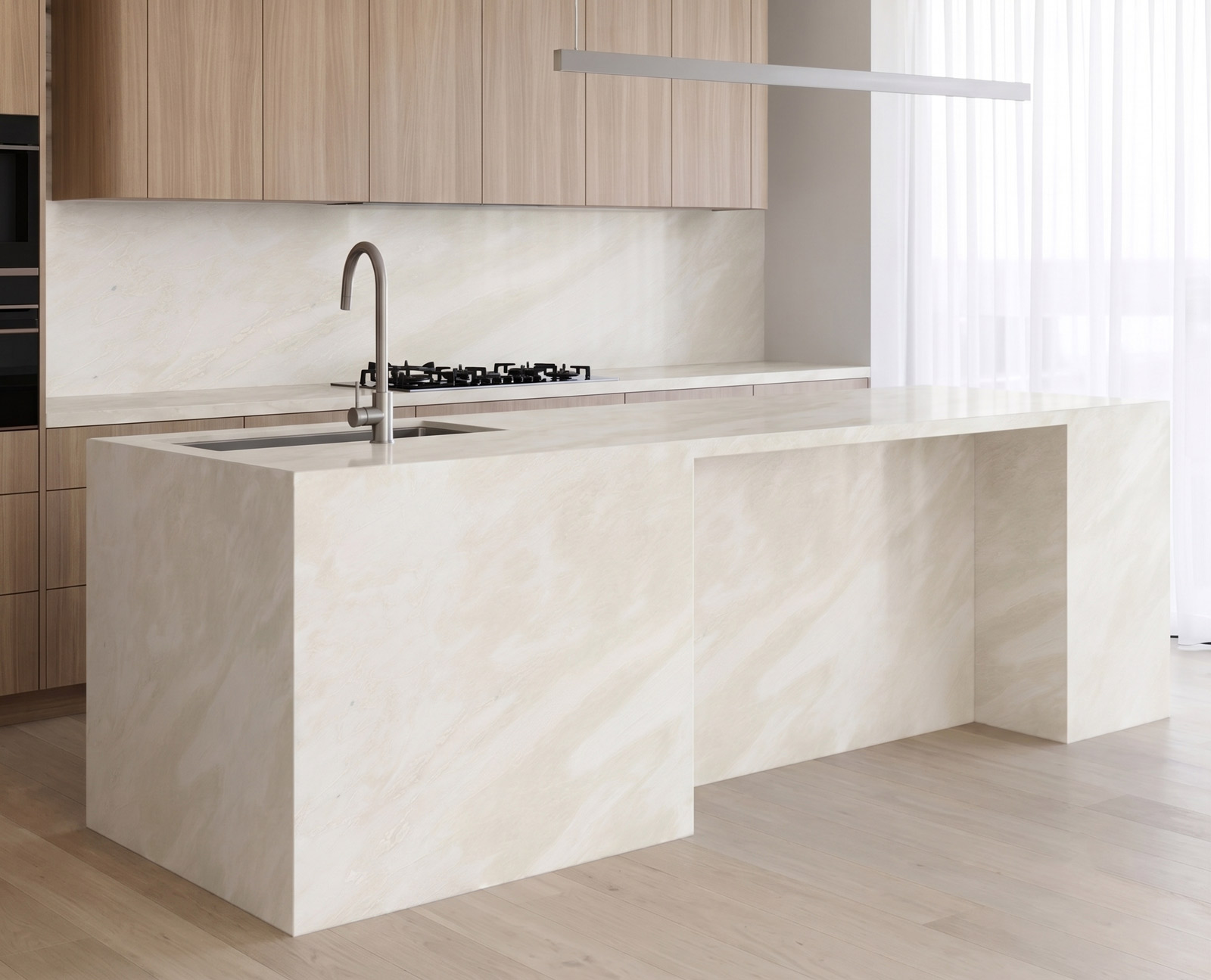 Modern kitchen showcasing a warm ivory white natural stone island bench and matching continuous splashback. The soft veining of the marble pairs beautifully with natural timber cabinets, timber floors, and sheer curtains