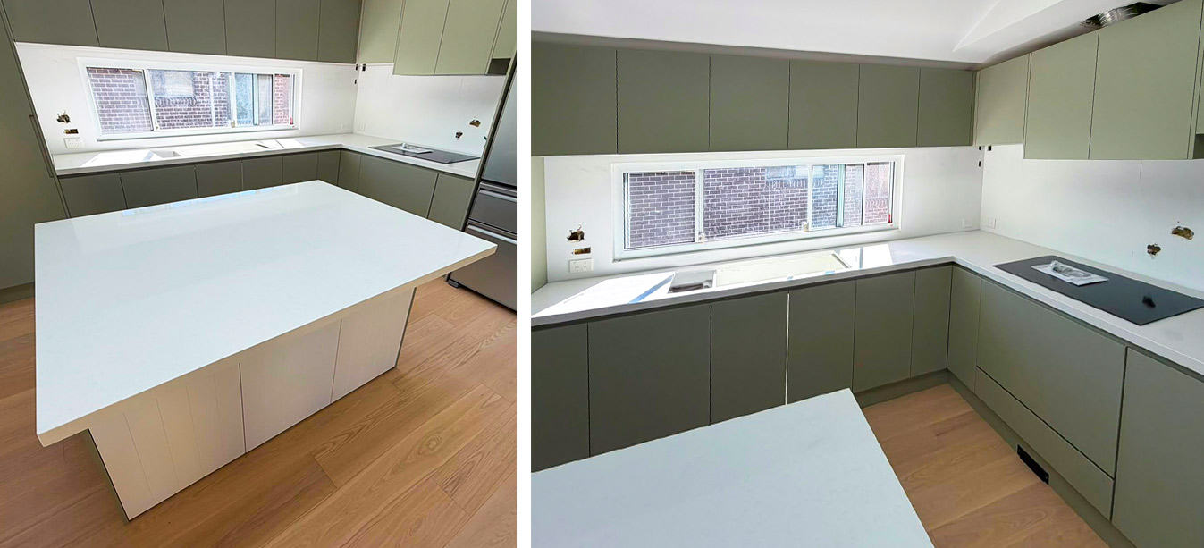Pure white engineered stone benchtop and waterfall island in a sage green handleless kitchen.