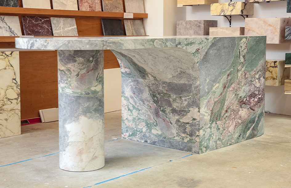 Curved Six Senses Marble island with cantilevered overhang, cylindrical stone column and curved waterfall end, honed finish, Marble Hub Sydney showroom