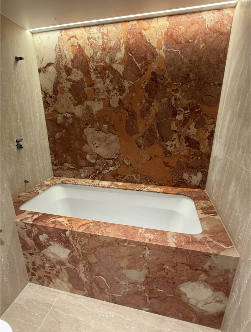 Breccia Rosso marble bath surround with a matching backlit Breccia Rosso feature wall, undermount bath, Sydney bathroom.