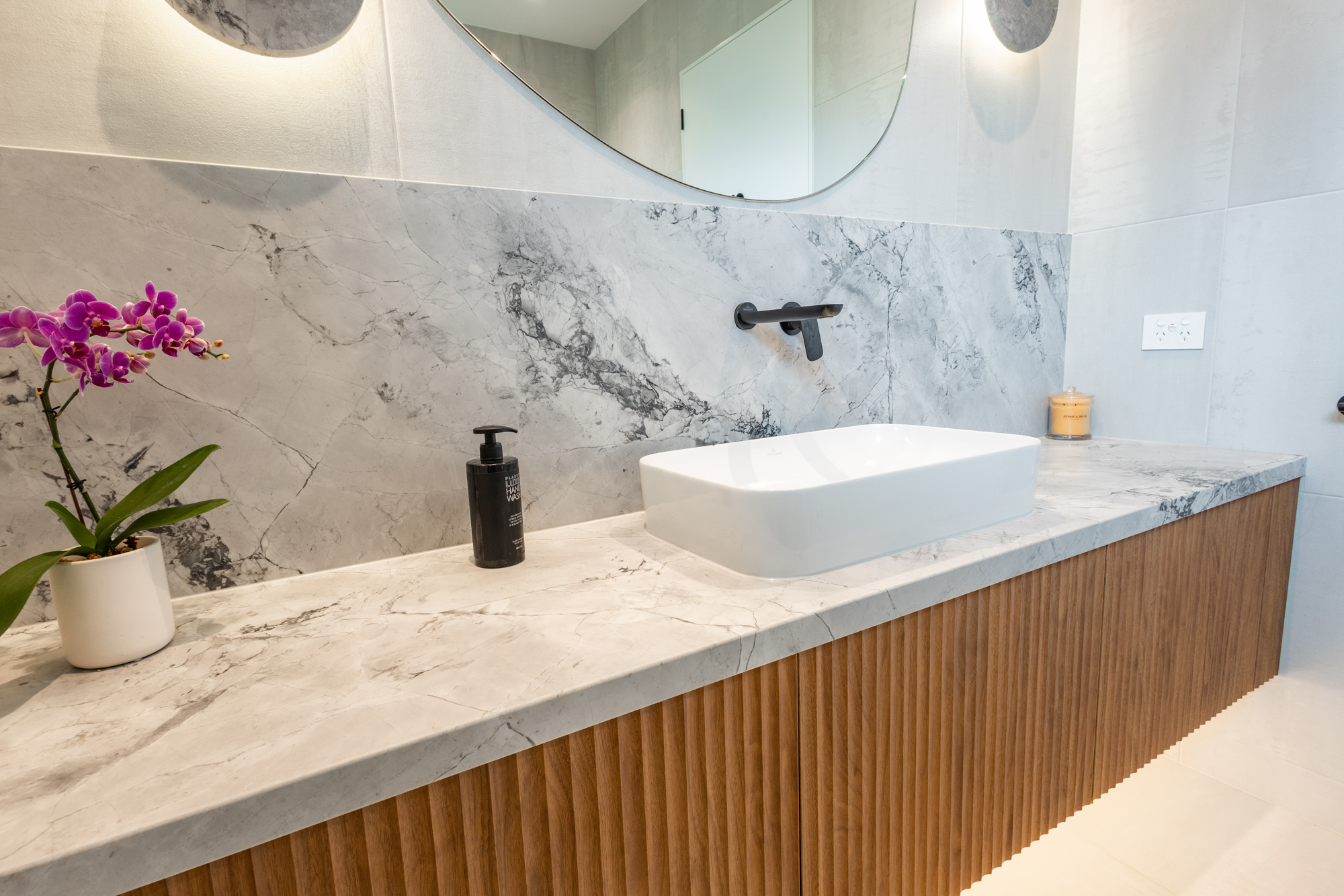 Super White quartzite vanity top with fluted oak joinery, above-counter basin, Sydney bathroom