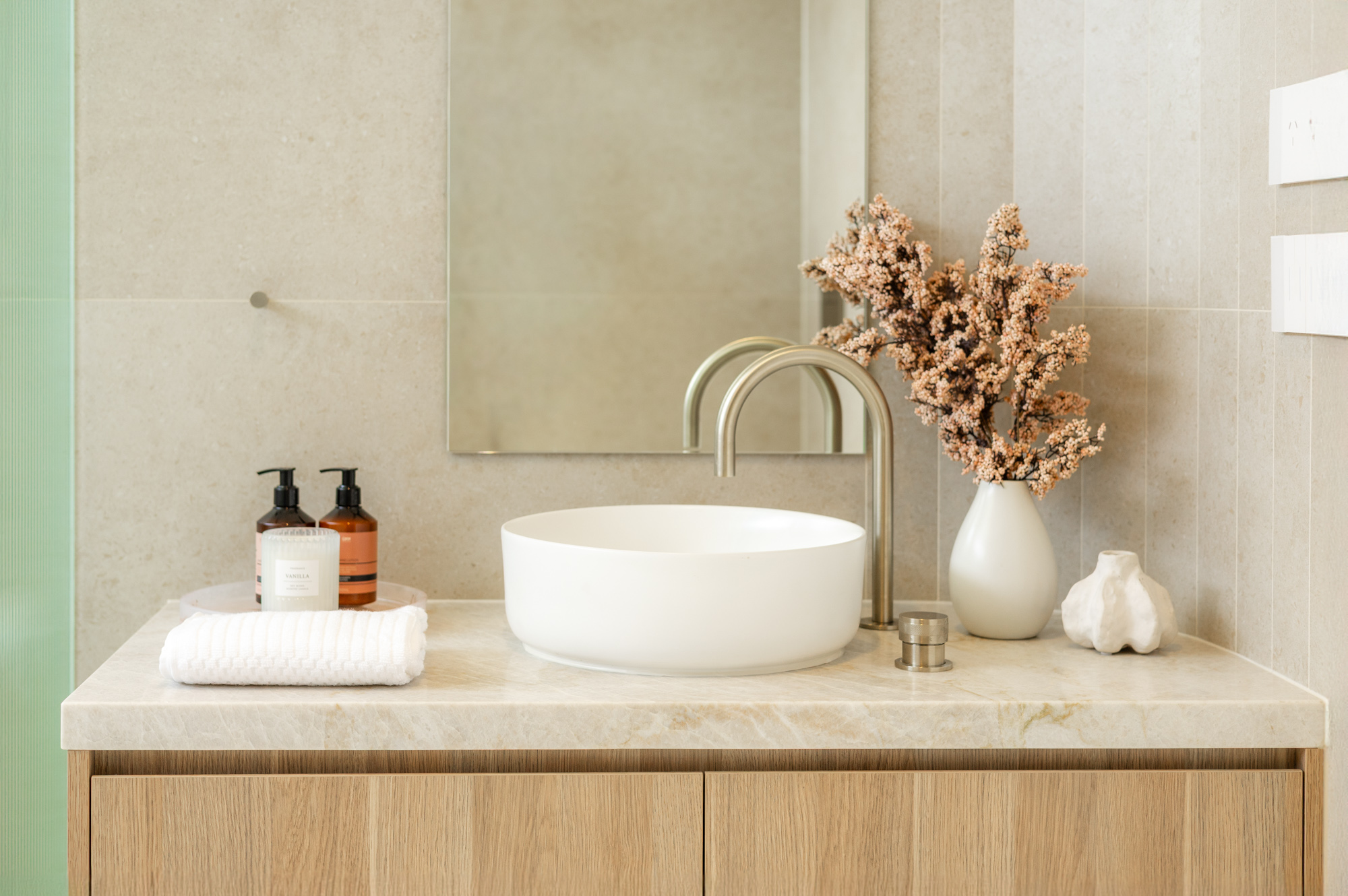 Taj Mahal quartzite vanity with stone cut around a freestanding curved basin, Sydney bathroom