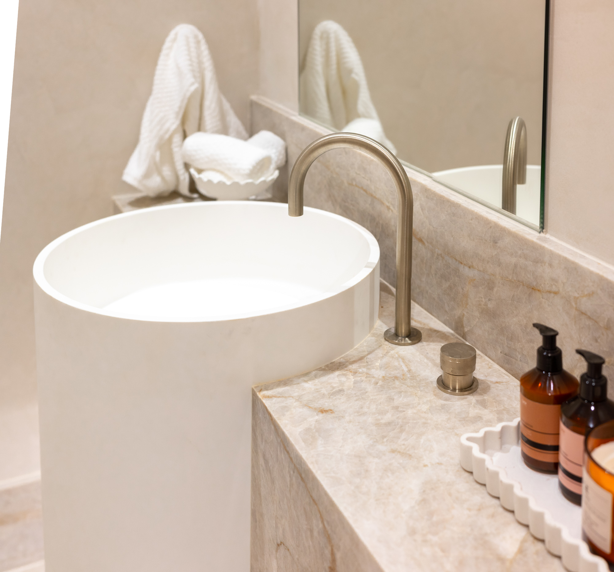 Taj Mahal quartzite vanity with stone cut around a freestanding curved basin, Sydney bathroom