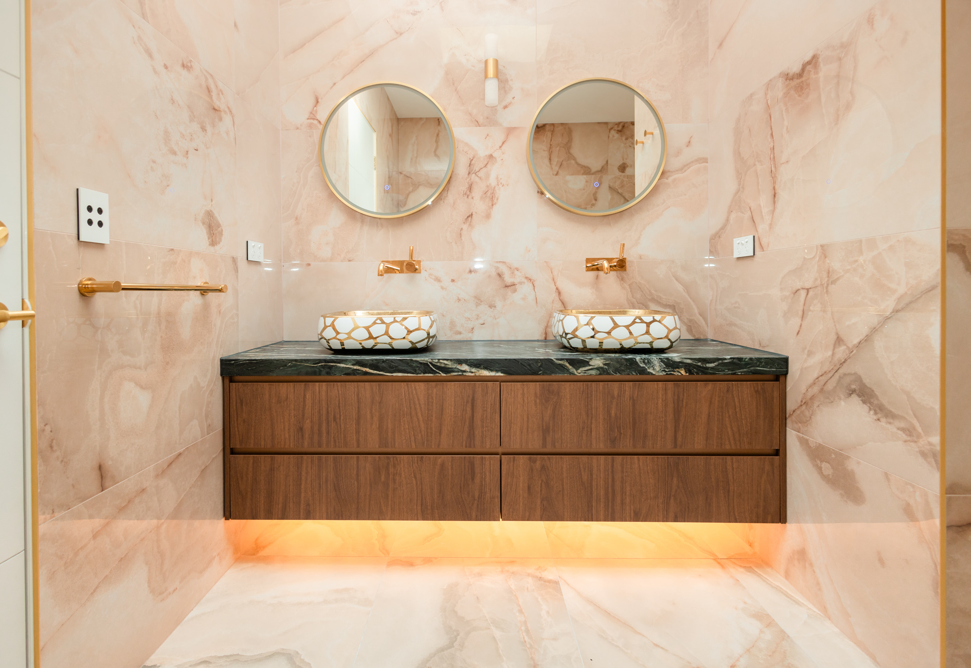 Deep green Arabescato Grigio Orobico marble vanity top, walnut joinery, gold basin, Sydney
