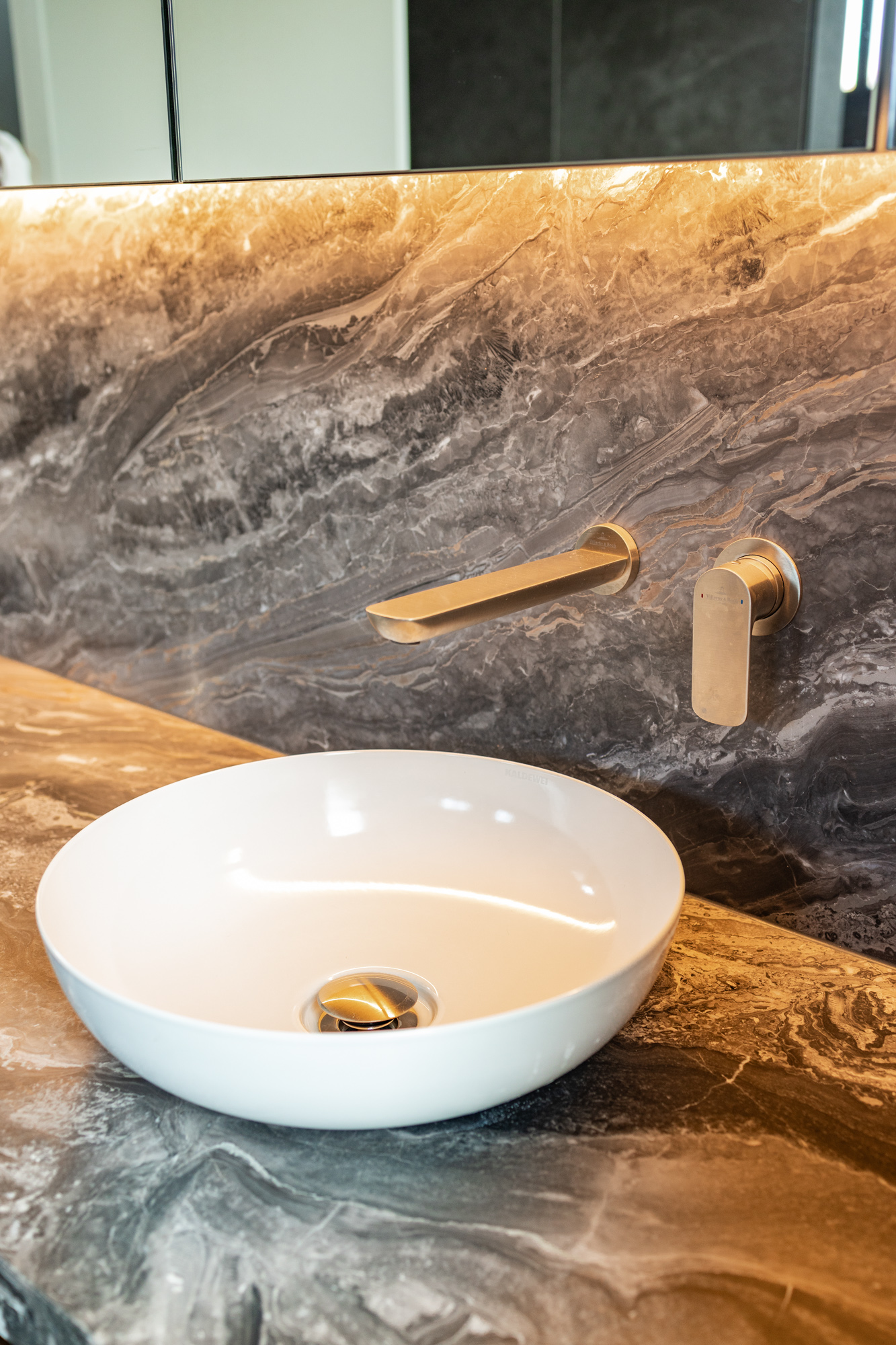 Belvedere granite vanity top with organic vein flow, white round basin, brushed gold tapware, Sydney bathroom
