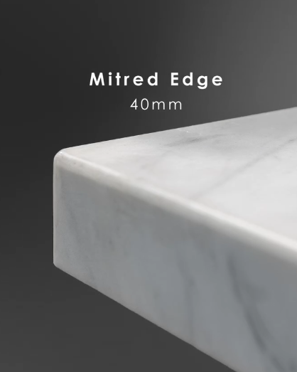 Mitred 40mm edge on a marble benchtop, sharp corner with veining running continuously over the block.