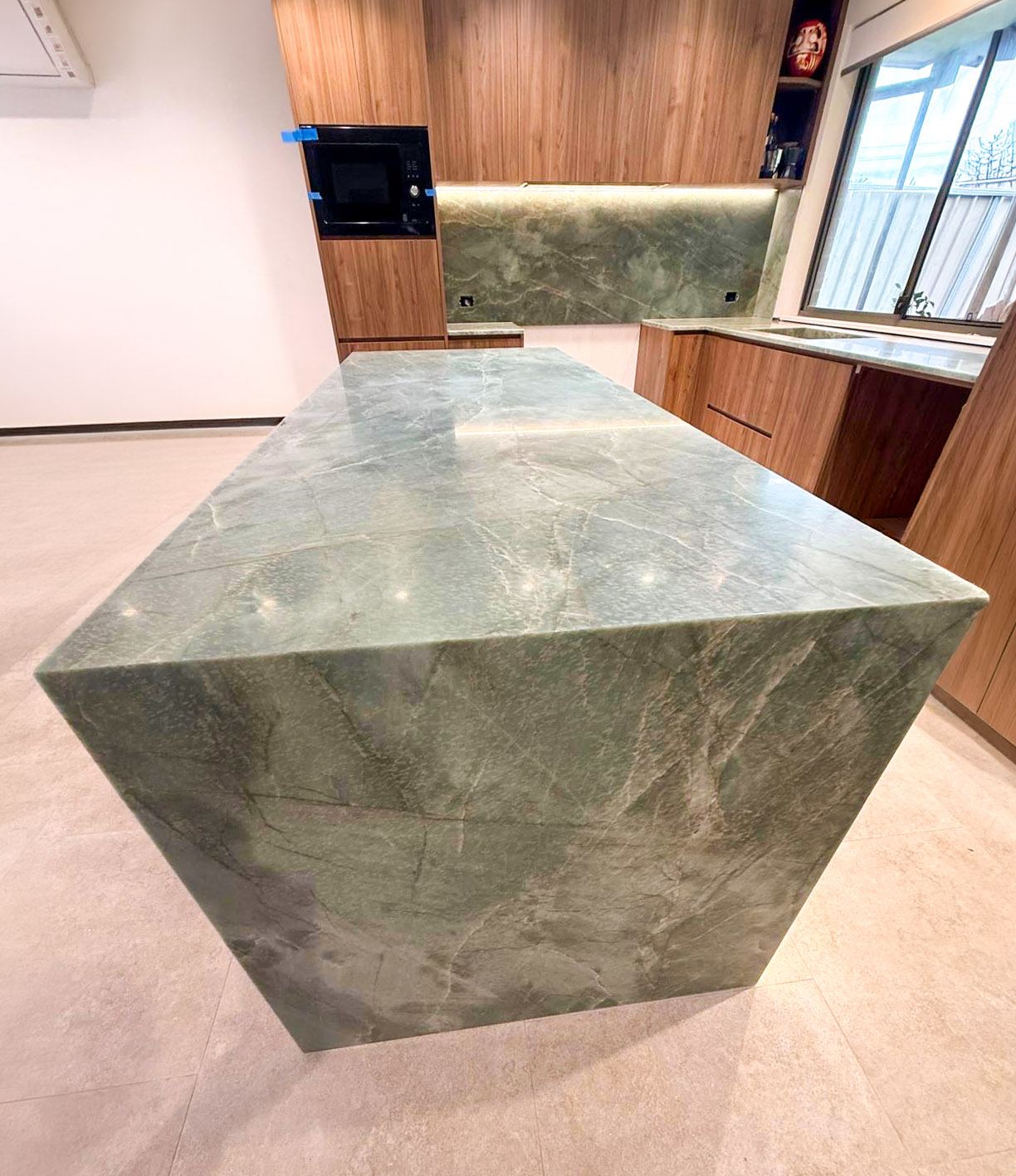 Mitred waterfall island in Esmeralda emerald green quartzite showing soft grey-green veining, Sydney