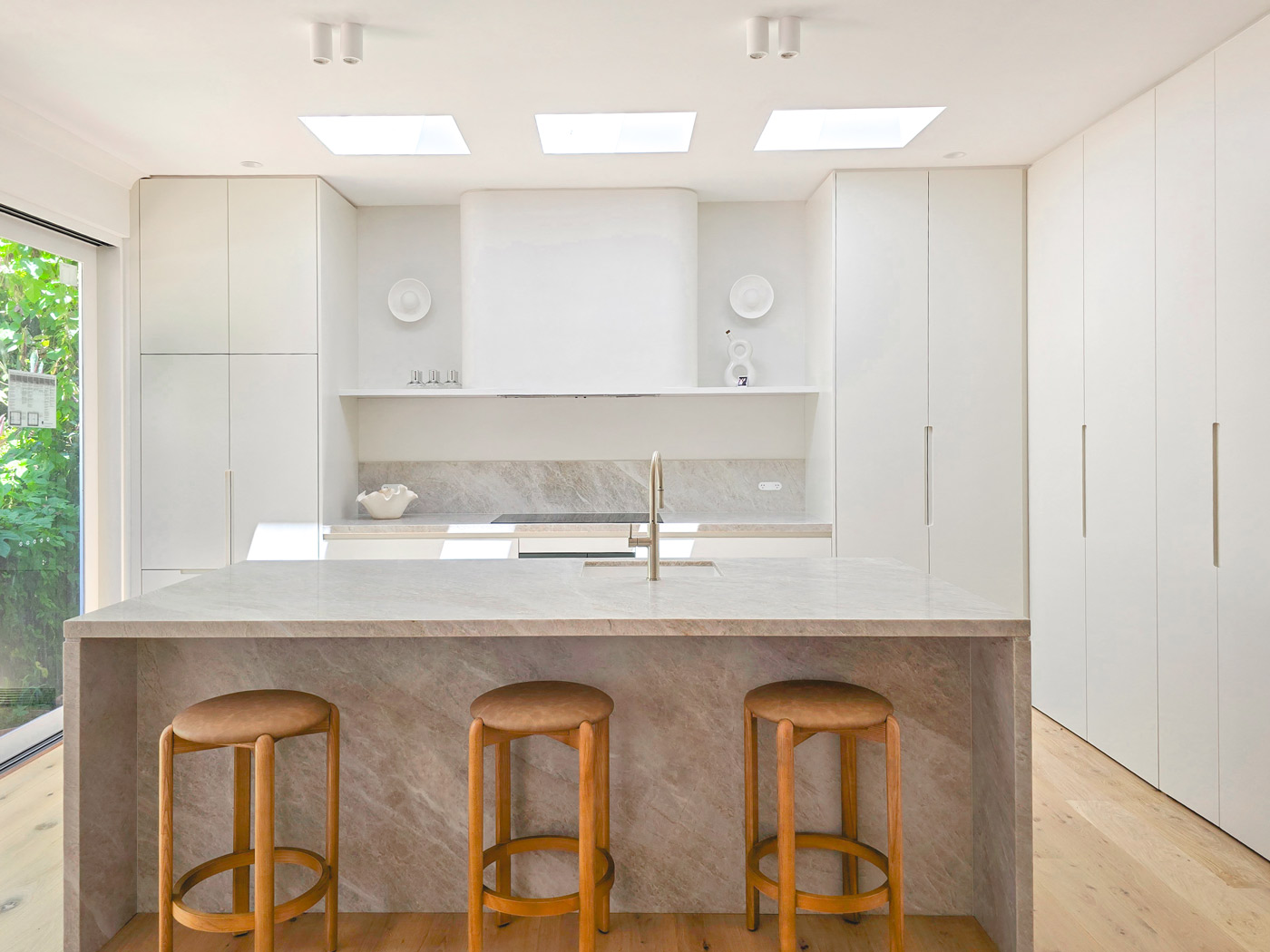 Taj Mahal quartzite benchtop with honed finish in a warm kitchen, Sydney
