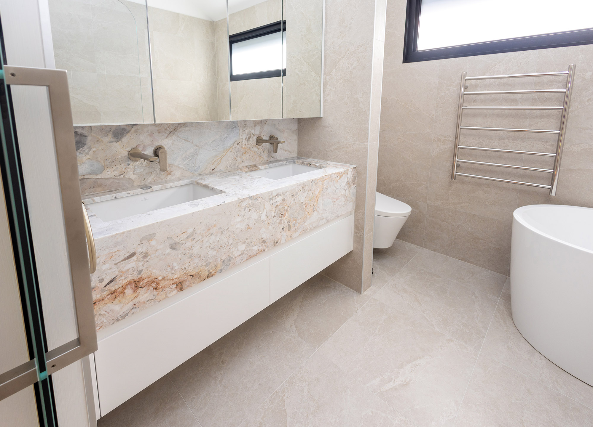 Aurora Milano stone vanity with freestanding bath and heated towel rail, Randwick bathroom, Sydney