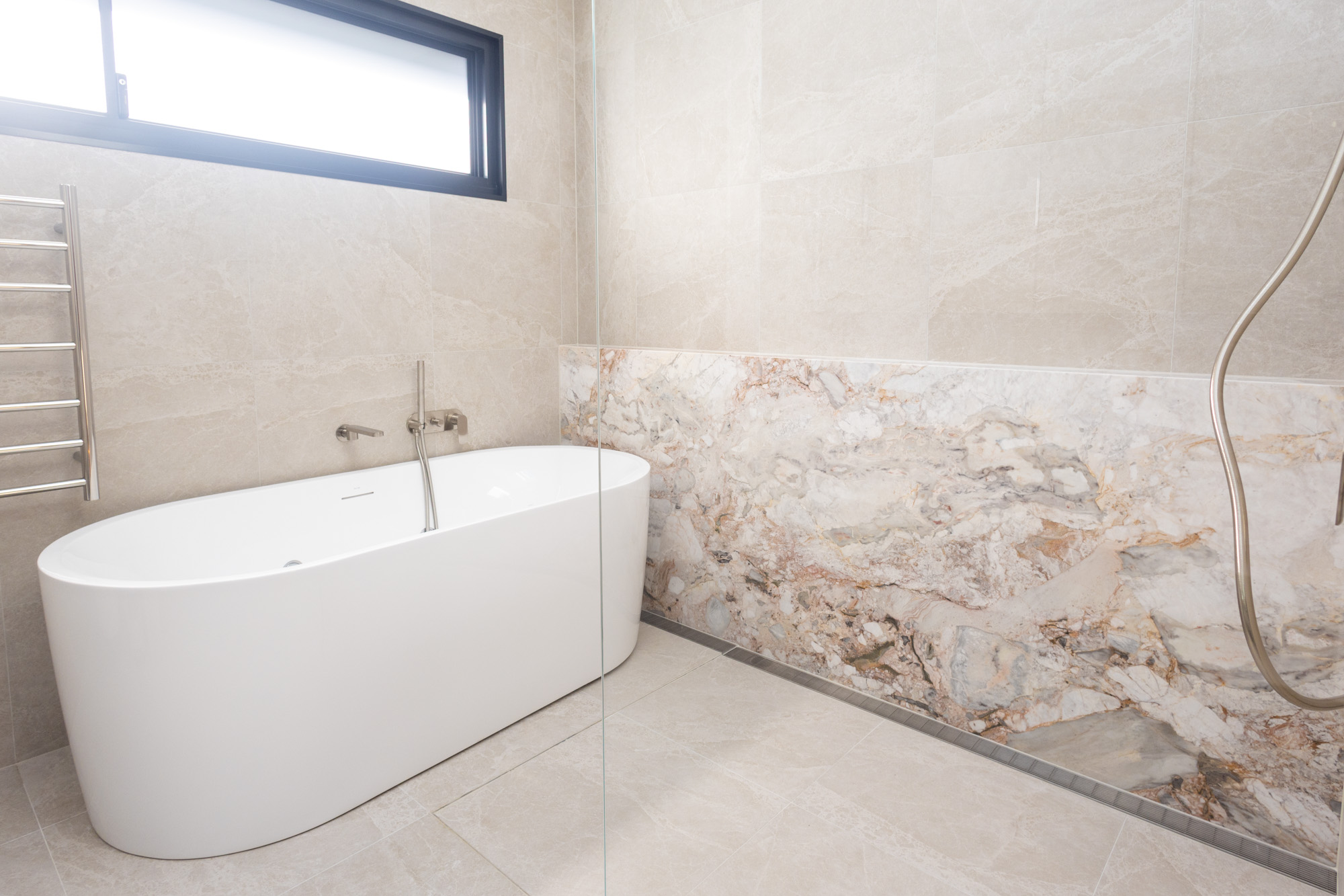Aurora Milano stone wall cladding behind a freestanding bath, Randwick bathroom, Sydney