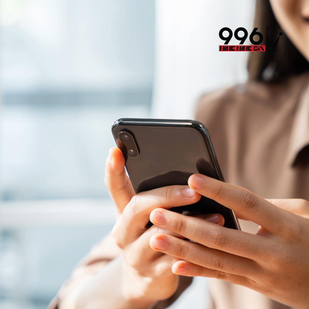 Woman holding a smartphone texting