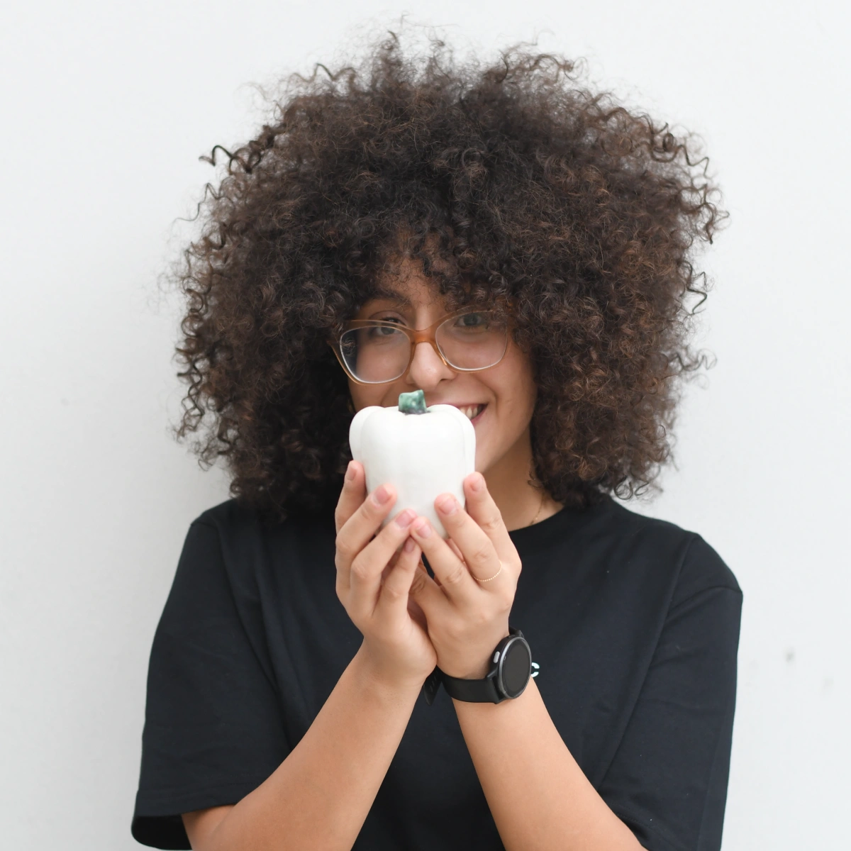 A professional headshot of Imane doing a fun pose