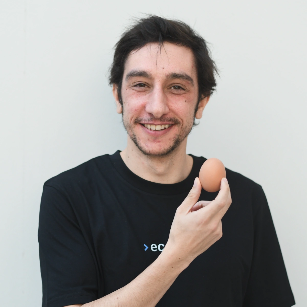 A professional headshot of Simao doing a fun pose