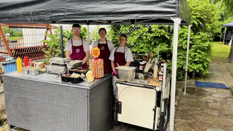Crew unter schwarzem Pavillon beim Sommerfest