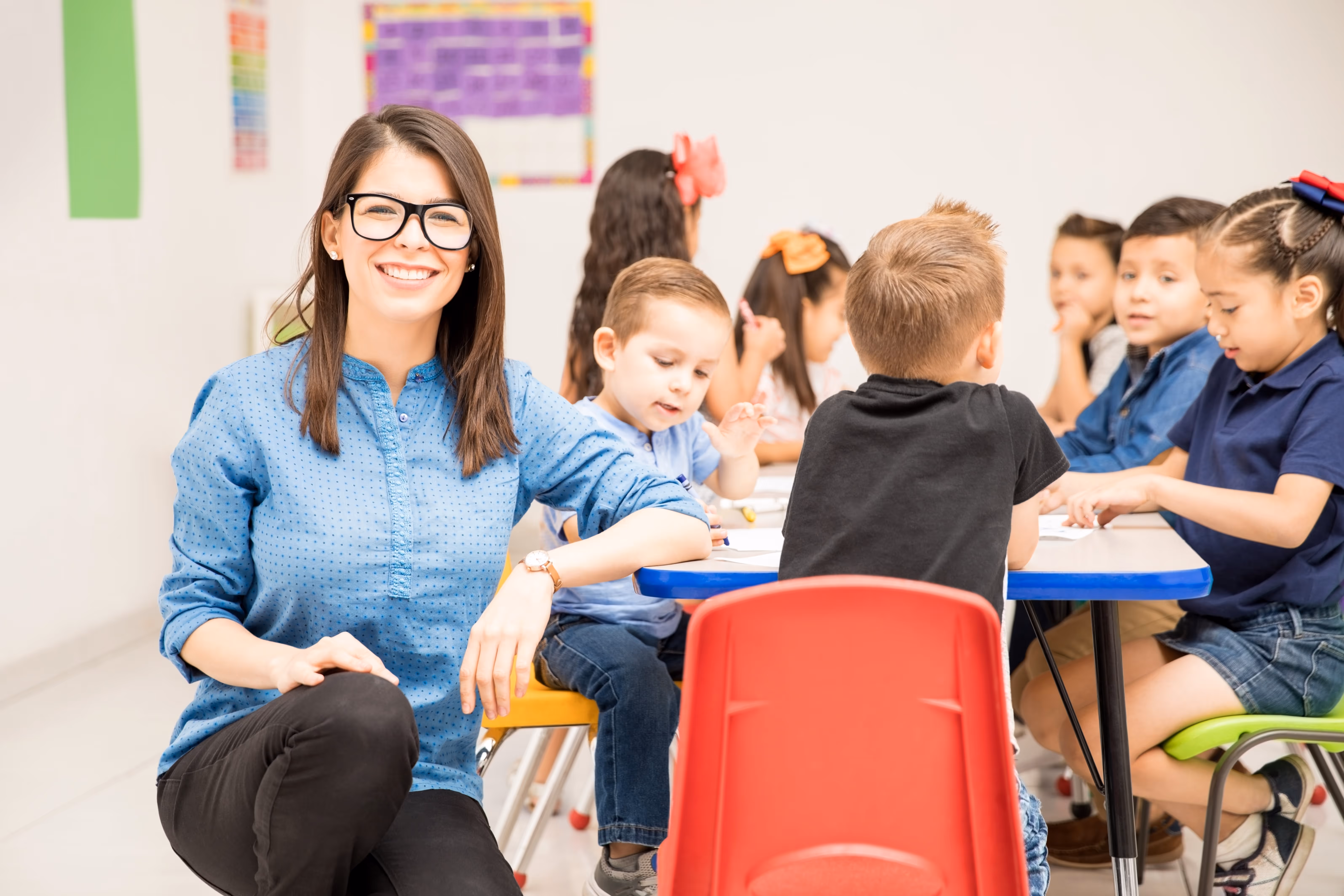 portrait-gorgeous-hispanic-preschool-teacher-loving-her-job-having-fun-with-her-pupils-min