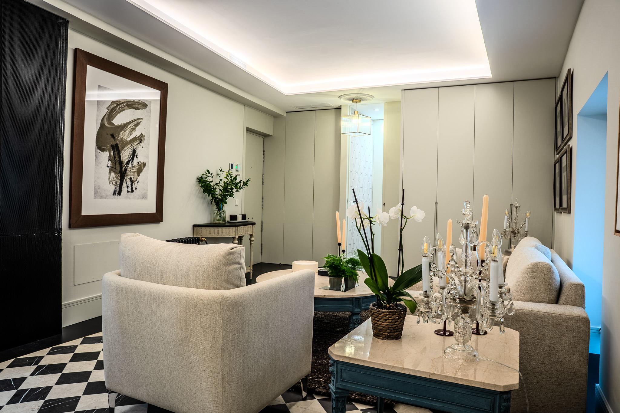 Salón hacia el recibidor, con butaca, sofá y aparador