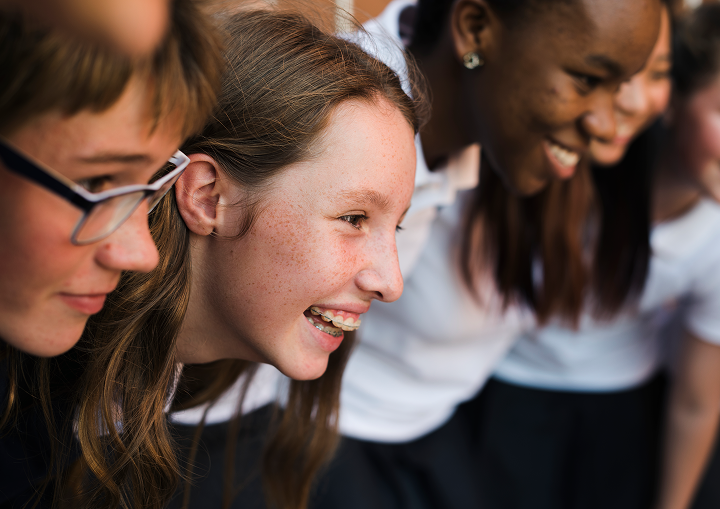 A group of excited young people smiling.