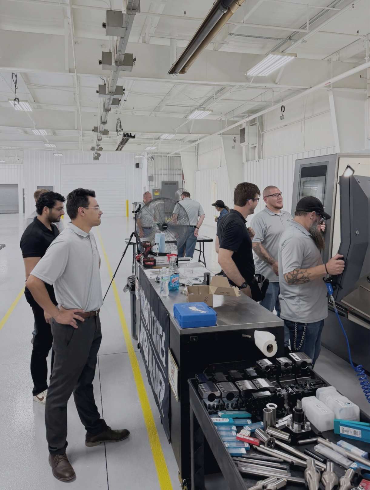Saginaw Precision team and Salient Motion leadership at a CNC machine inside the SP-1 facility in Saginaw, Michigan