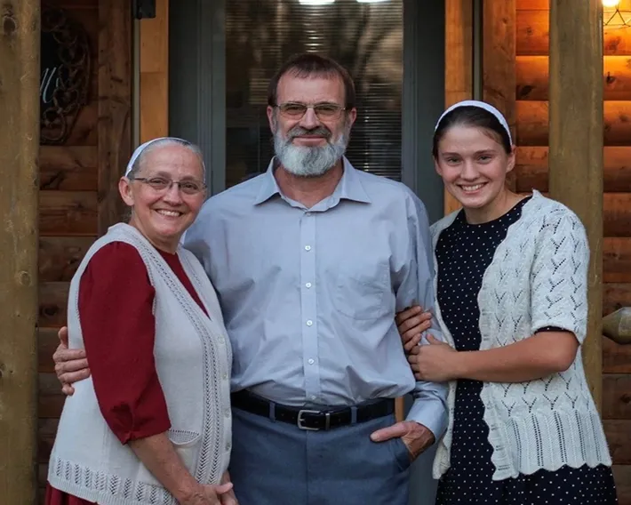 David, co-owner, posing with his wife and daughter.