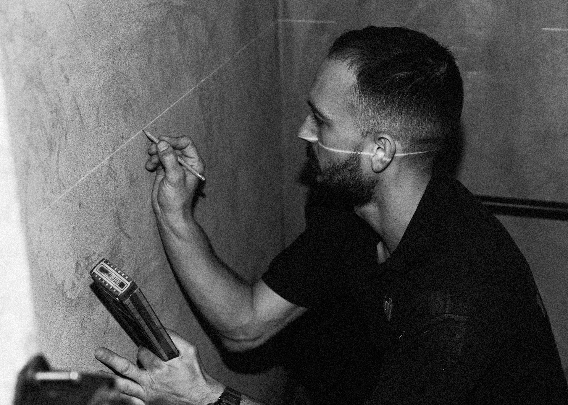 LDB construction worker carefully measuring a cutting line