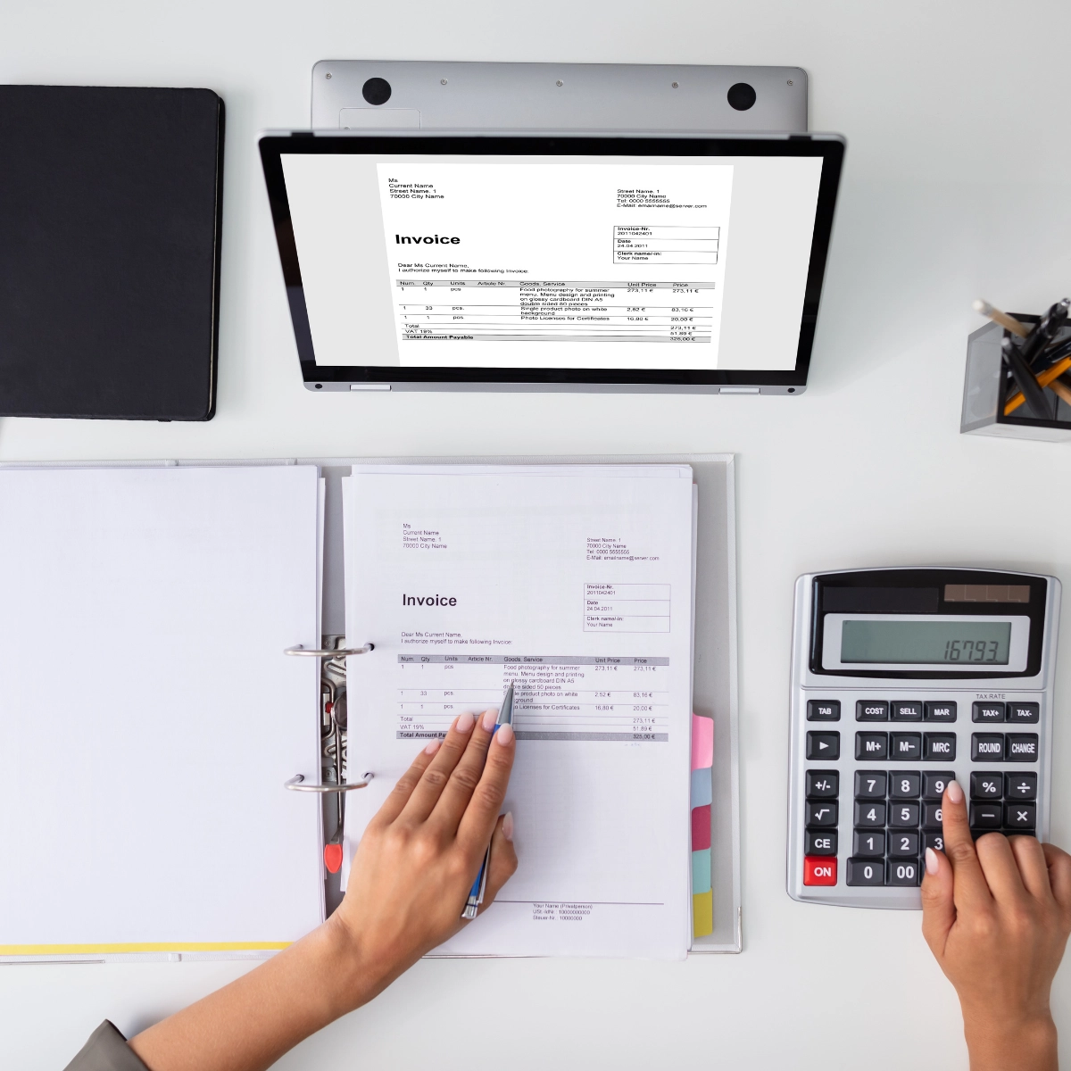 Image of a desk with an invoice and a calculator.