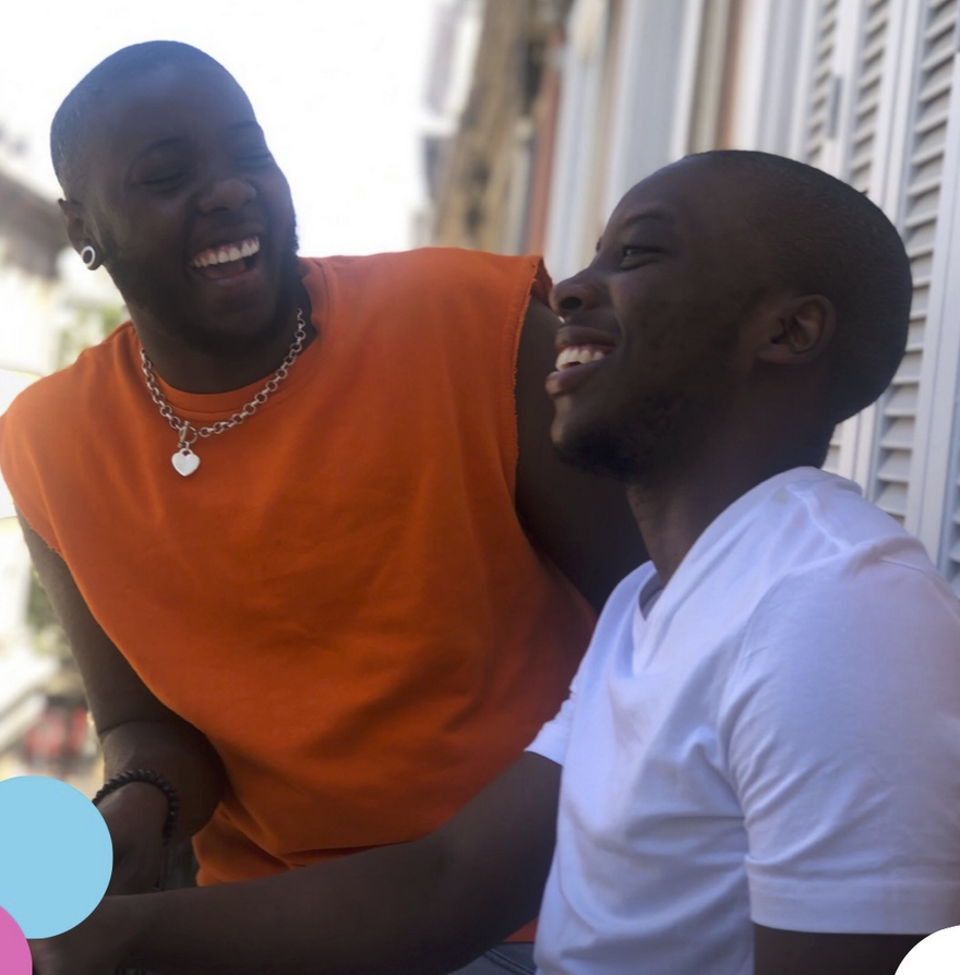Two peope laughing together