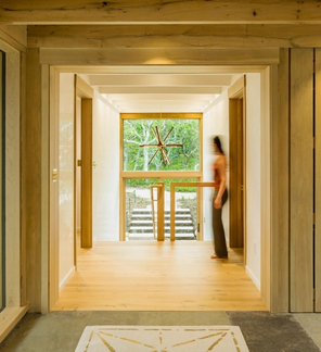 Interesting wood slat room divider between kitchen and stairs.