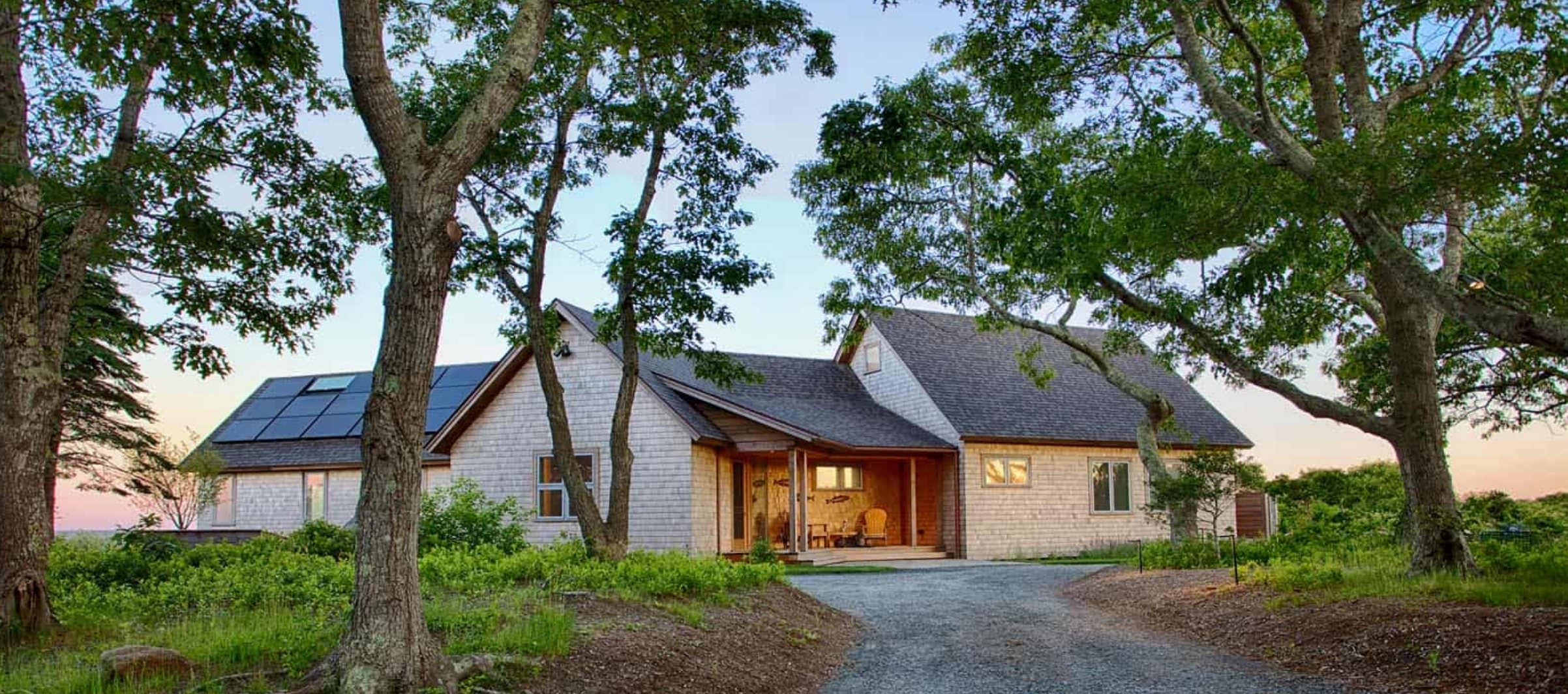 New custom house with pool and screen porch at dusk.