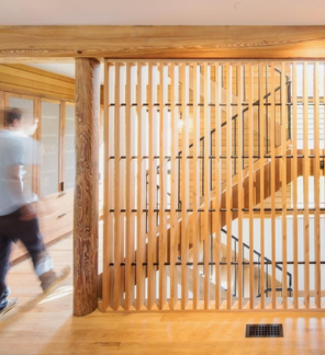 Interesting wood slat room divider between kitchen and stairs.