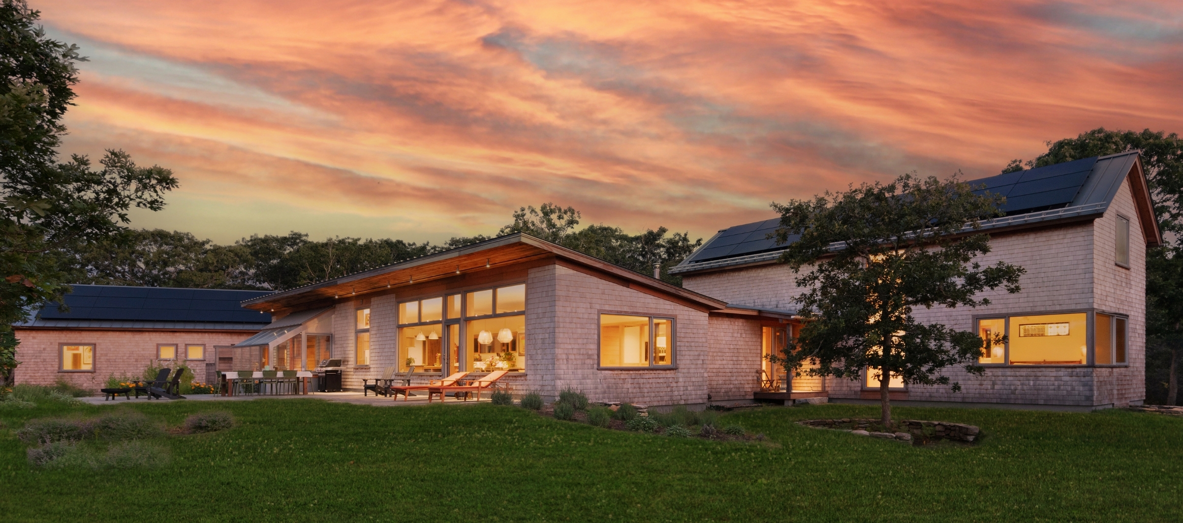 New custom house with pool and screen porch at dusk.