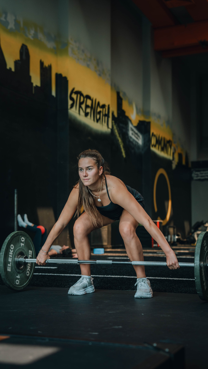 Female client performing strength training for weight loss training in East Liberty