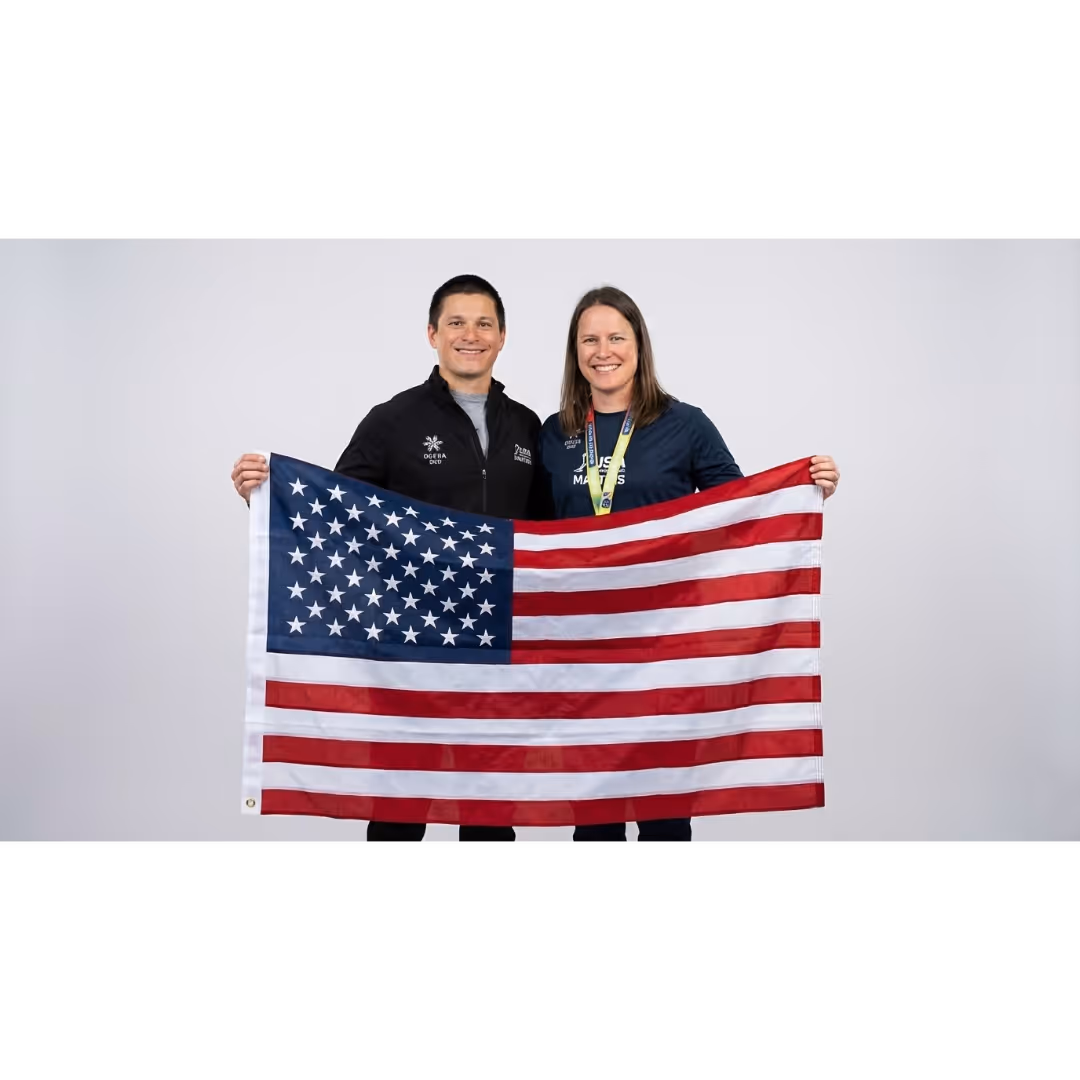 A female athlete holding the U.S.A flag after being selected for the Women Field Hockey team.