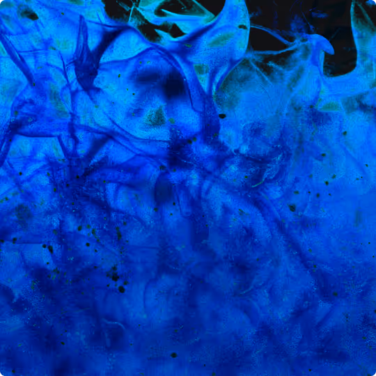 Abstract swirling blue smoke or ink texture with varying shades and wisps.