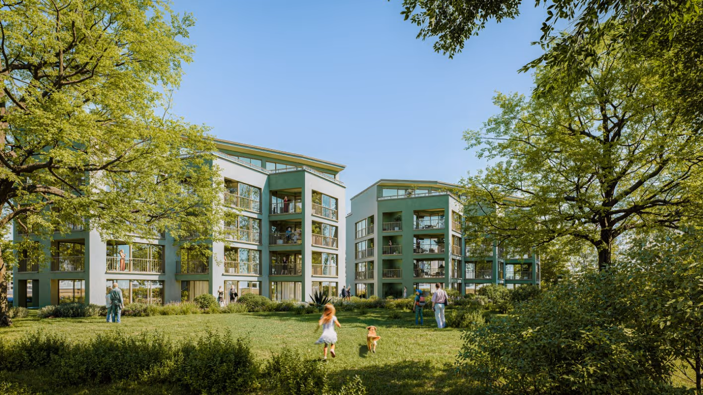 Moderne Wohngebäude mit großen Fenstern, umgeben von grünen Bäumen und einer Wiese, auf der Menschen und ein Kind mit einem Hund spielen.