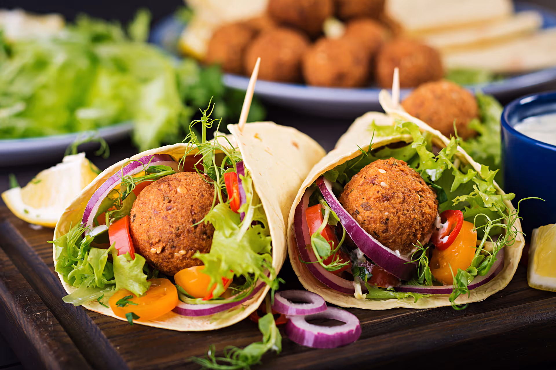 2 falafels with onion, lettuce, and tomatos