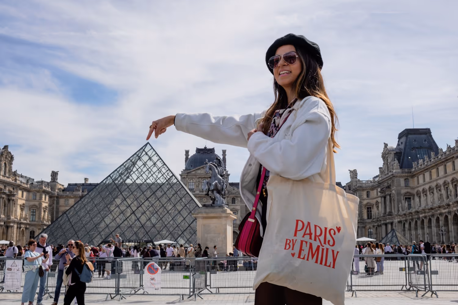 Walking Tour Guide pointing at top of louvre