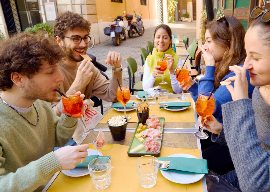 Food Tour - Aperol spritz and food, group of friends at a table