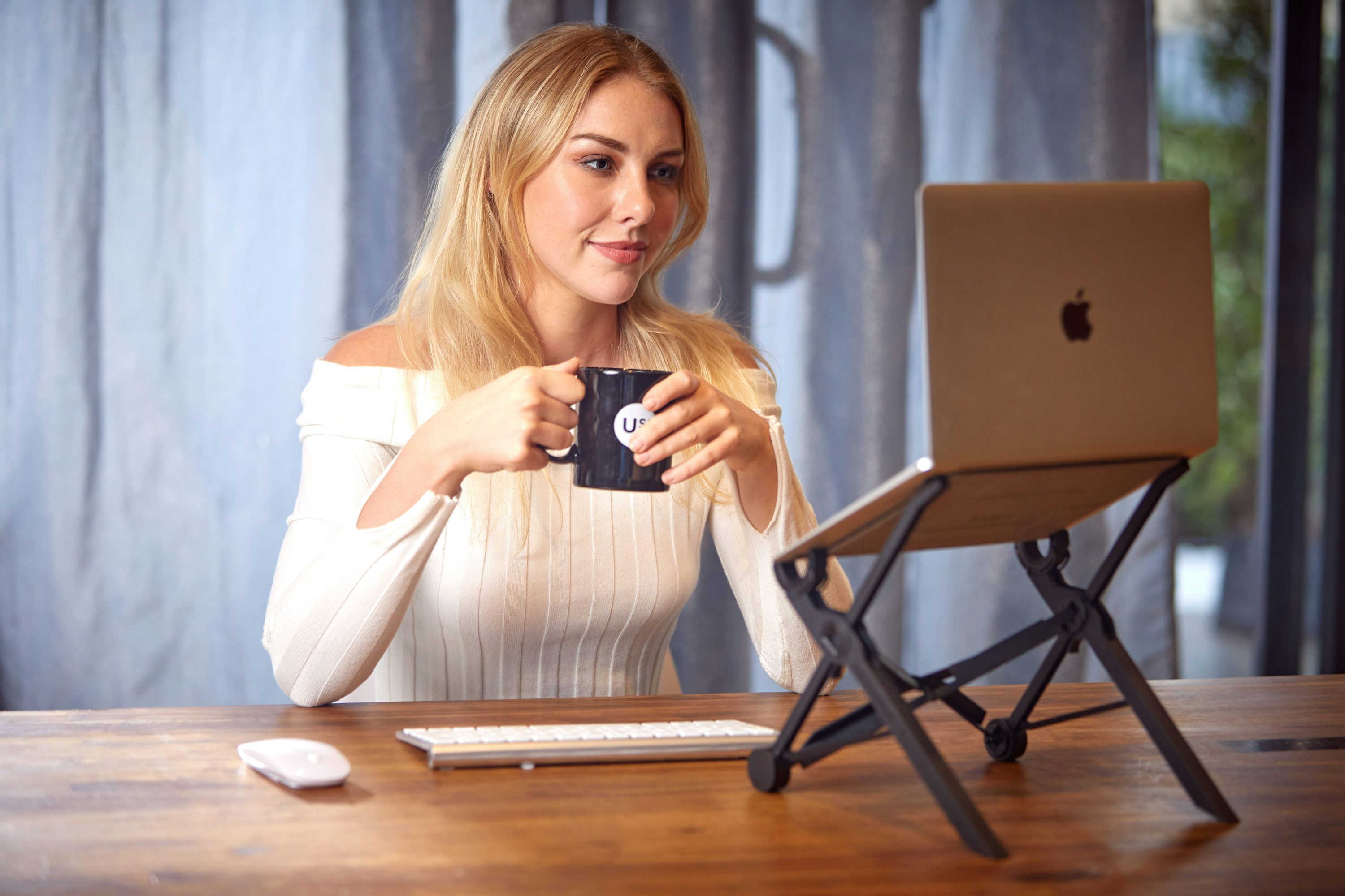 a woman sitting at a table with a laptop- Are Crypto Trading Bots Profitable
