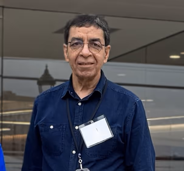 A male person in a blue shirt and with glasses on