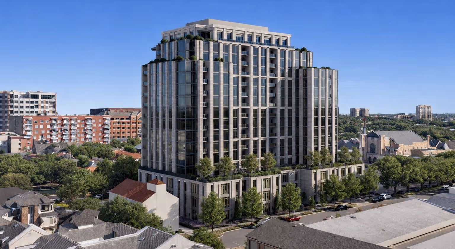 4211Newton Revised Photo 185' 16-story residential building with stepped terraces and trees on balconies under clear blue sky.