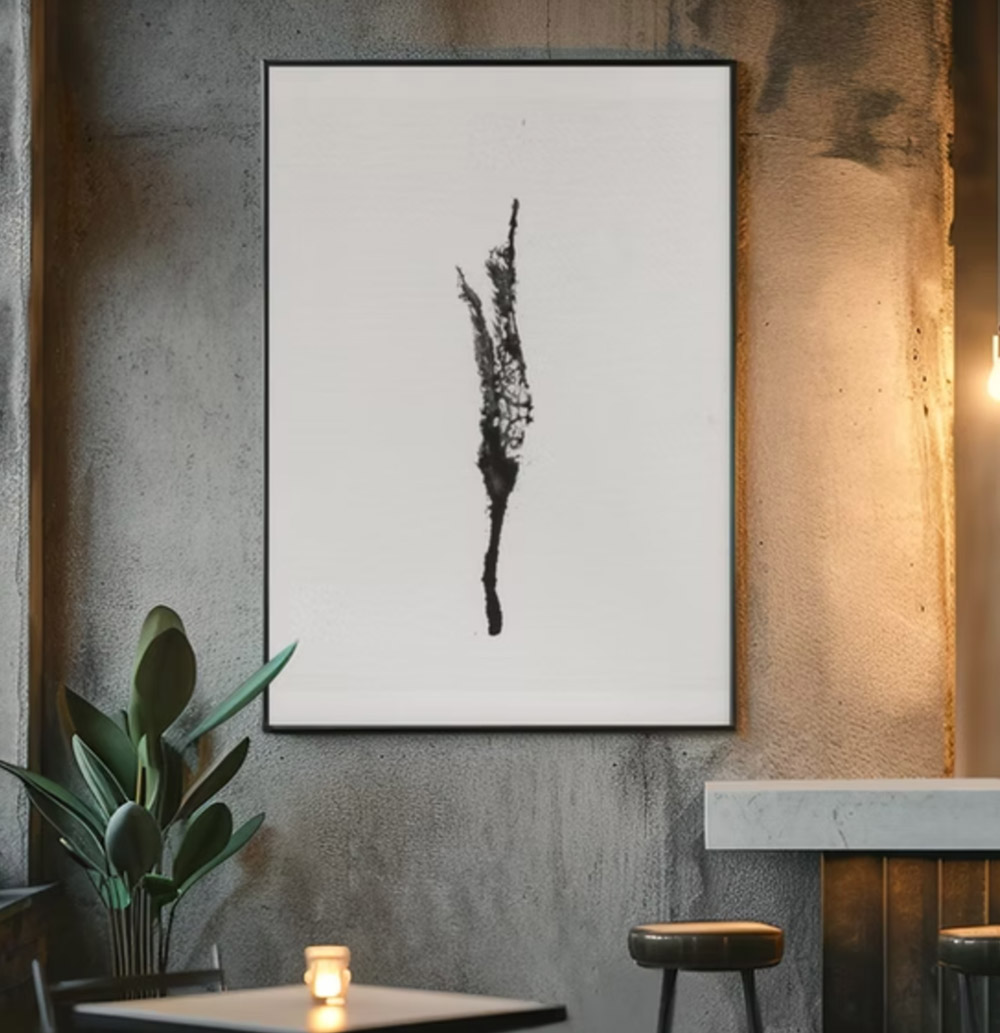 Minimalist black yoni print on white canvas, framed and hanging on a concrete gray wall. 